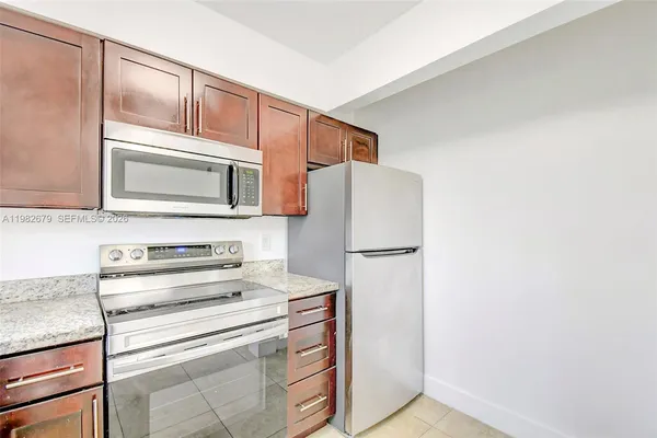 a kitchen with a refrigerator sink and microwave