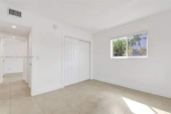 a view of an empty room with a window