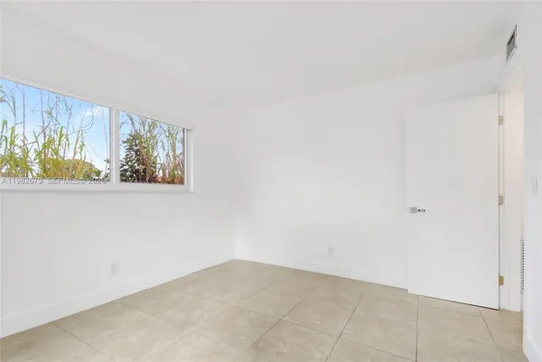 a view of an empty room with a window