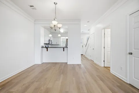 a view of a room with wooden floor and staircase