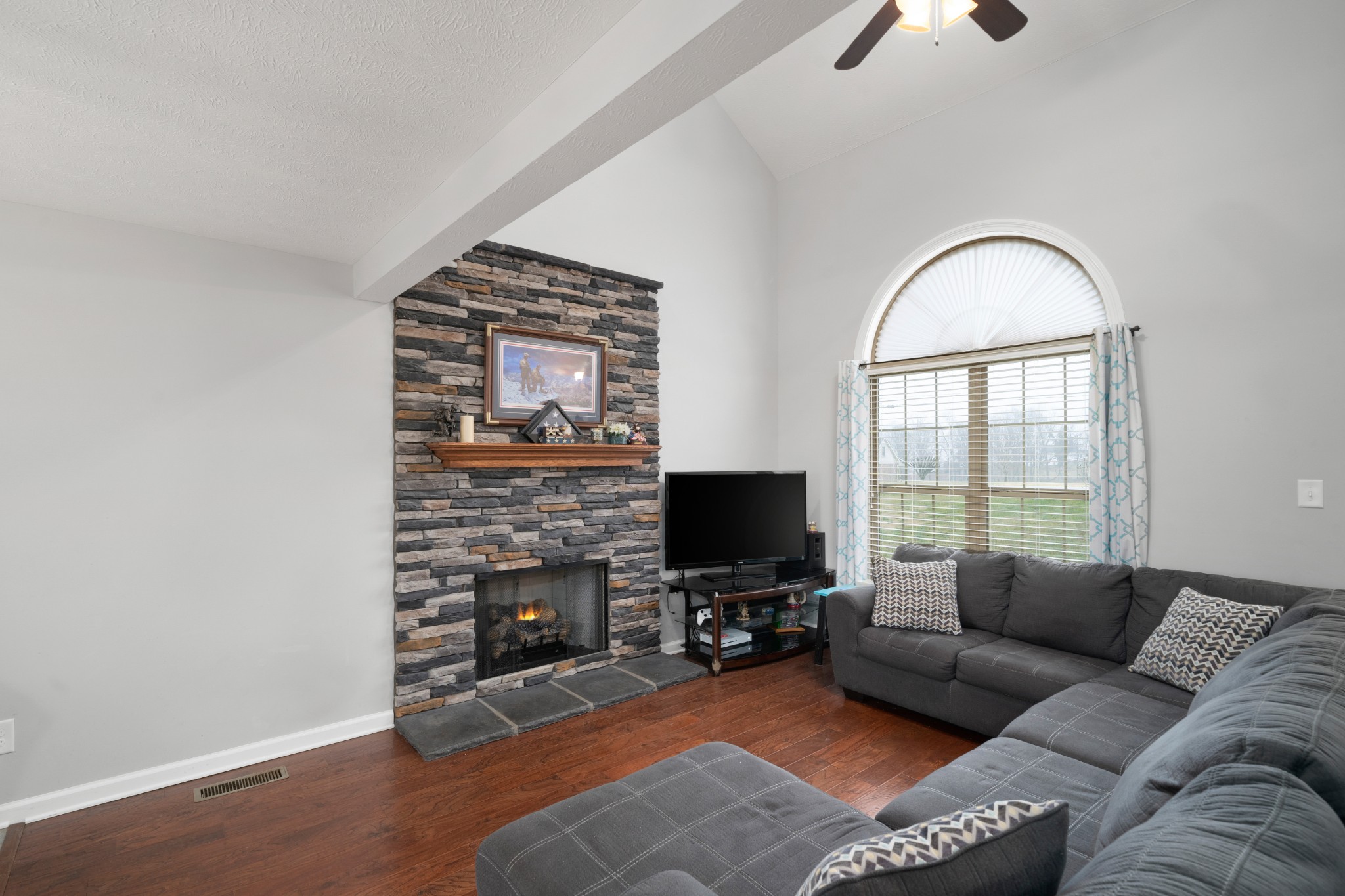 4218 Station Road Cunningham, TN 37052 - Photo 16 of 32 a living room with furniture a fireplace and a flat screen tv
