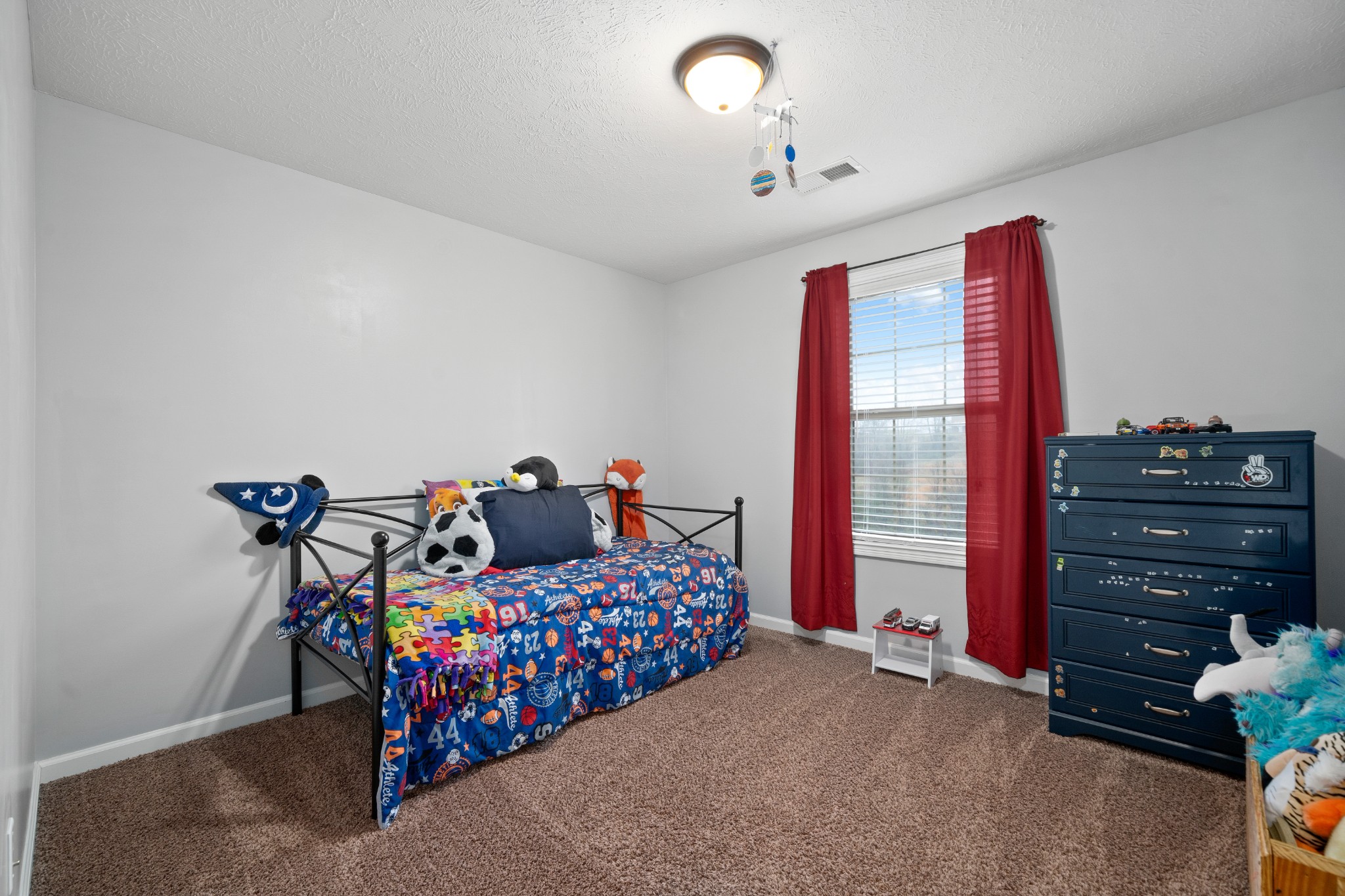 4218 Station Road Cunningham, TN 37052 - Photo 24 of 32 a bedroom with a bed and a chandelier
