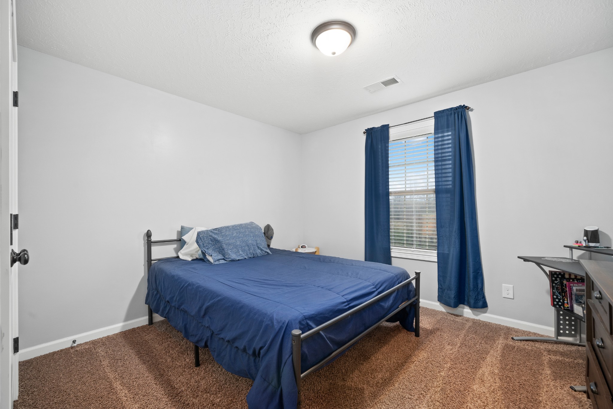 4218 Station Road Cunningham, TN 37052 - Photo 26 of 32 a bed sitting in a spacious bedroom next to a window