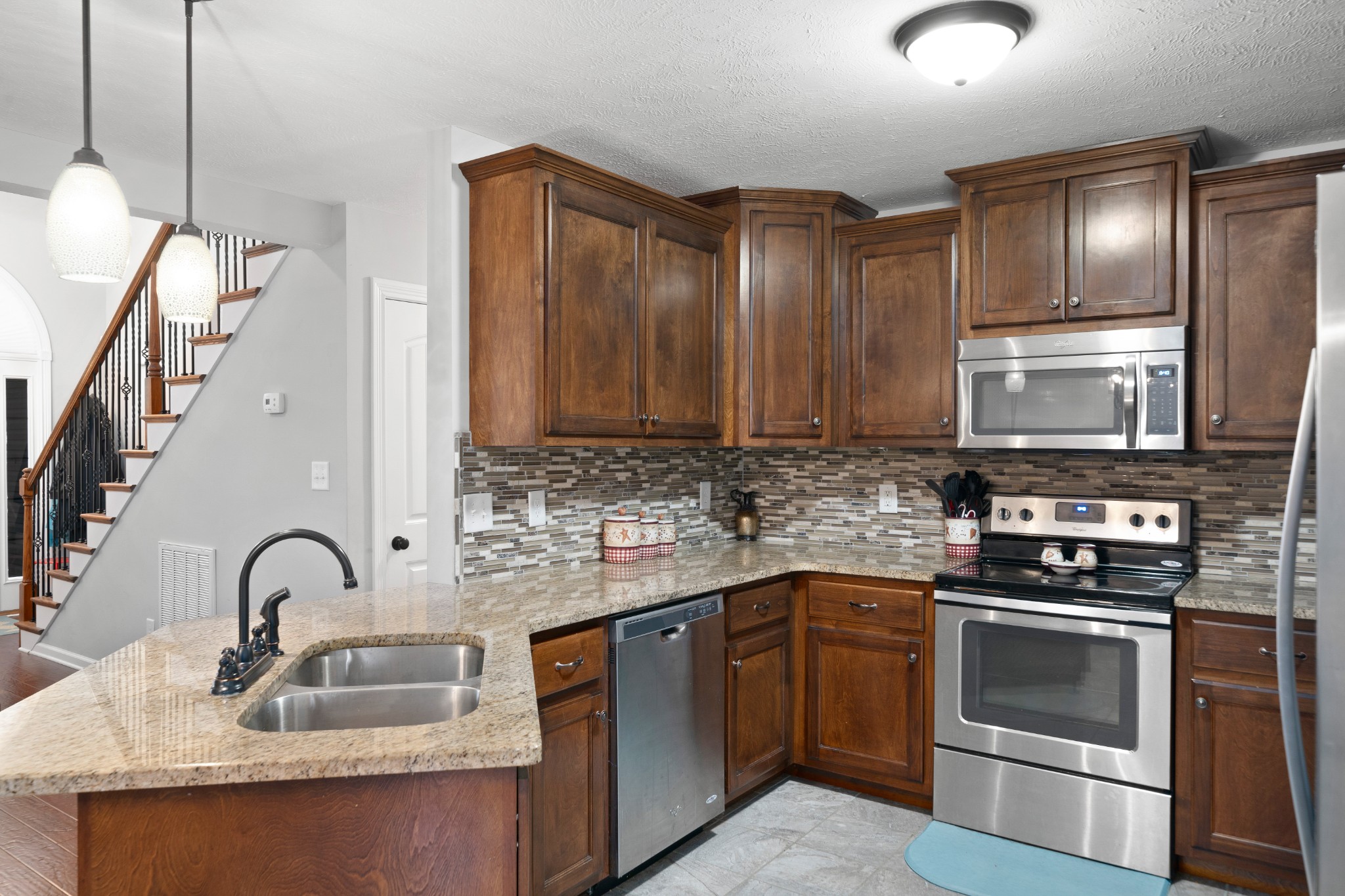 4218 Station Road Cunningham, TN 37052 - Photo 8 of 32 a kitchen with granite countertop a sink stainless steel appliances and cabinets