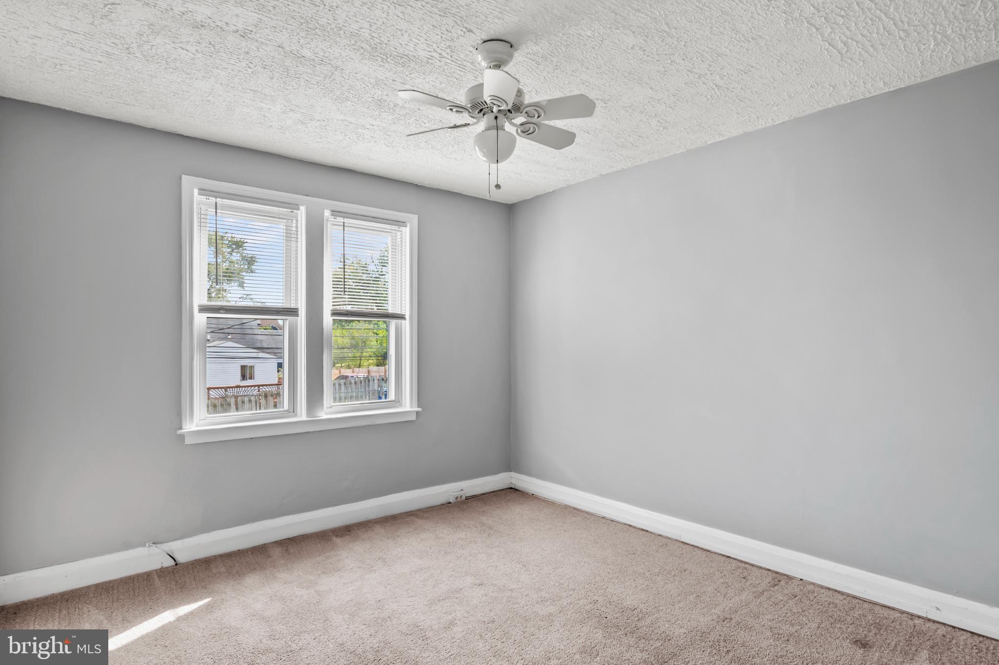 1411 Filbert Street, Unit 2 Curtis Bay, MD 21226 - Photo 11 of 13 an empty room with a window and a ceiling fan