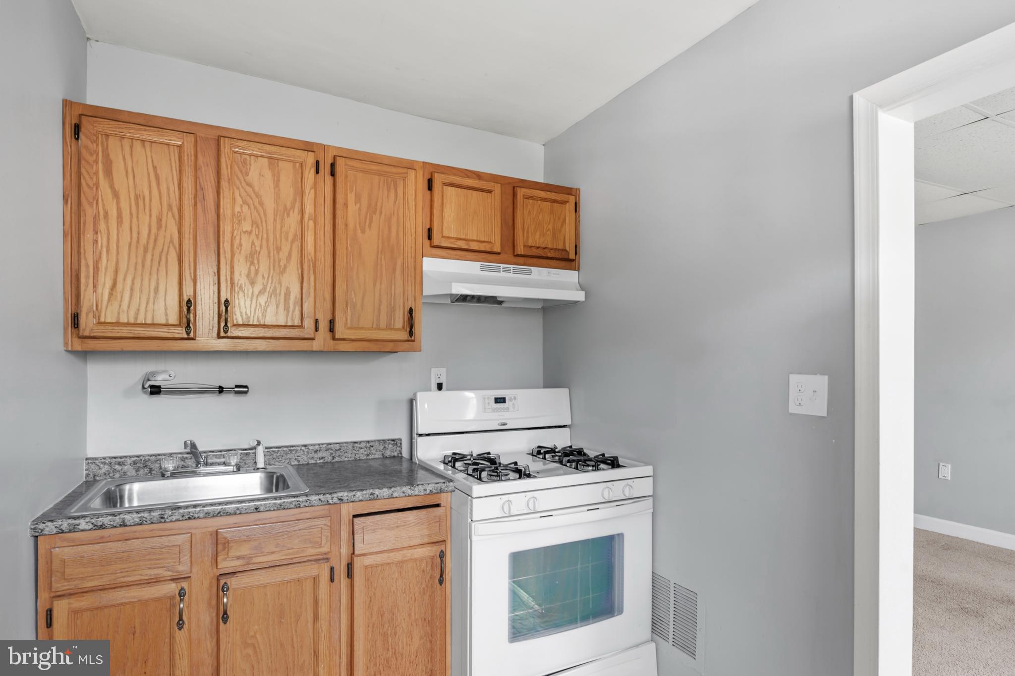1411 Filbert Street, Unit 2 Curtis Bay, MD 21226 - Photo 5 of 13 a kitchen with stainless steel appliances granite countertop a stove a sink and a microwave