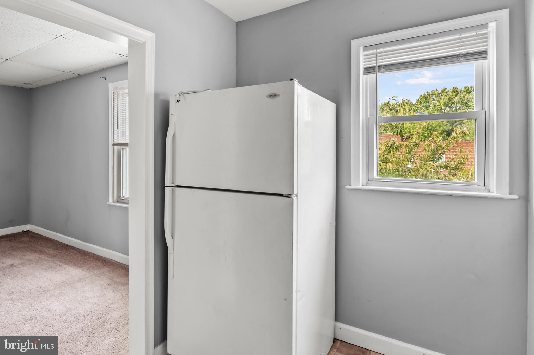 1411 Filbert Street, Unit 2 Curtis Bay, MD 21226 - Photo 7 of 13 a white refrigerator freezer and a window