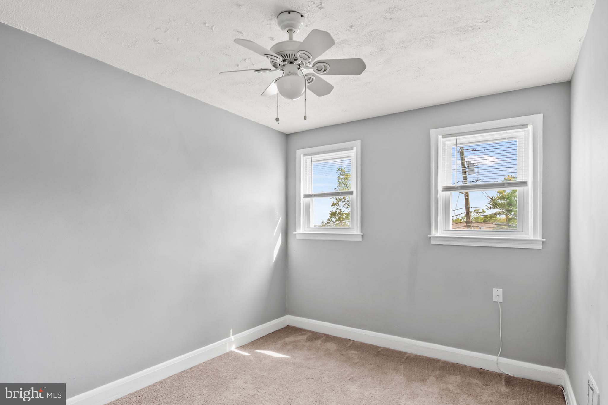 1411 Filbert Street, Unit 2 Curtis Bay, MD 21226 - Photo 8 of 13 an empty room with windows and fan