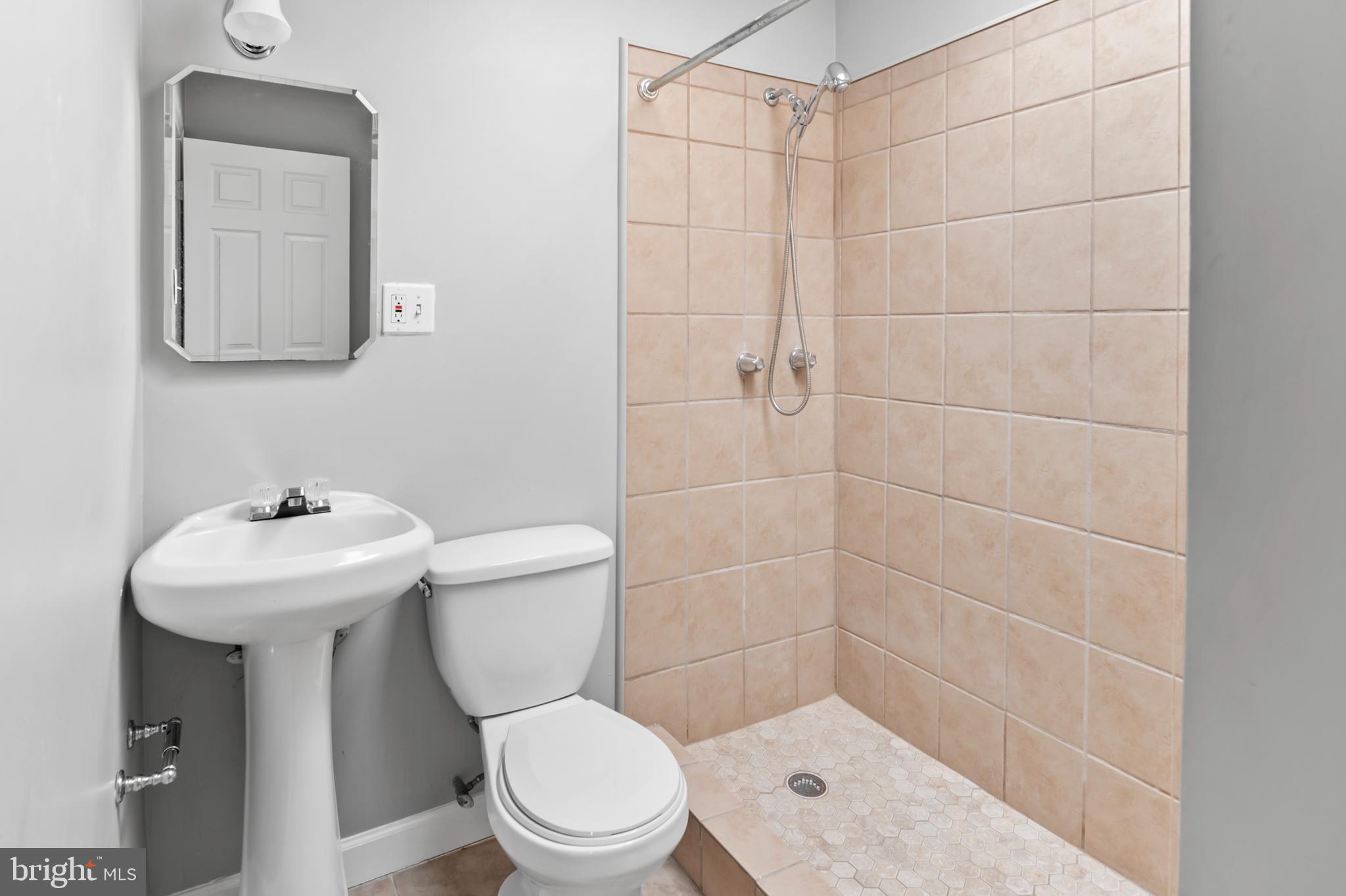 1411 Filbert Street, Unit 2 Curtis Bay, MD 21226 - Photo 10 of 13 a bathroom with a sink a toilet and shower