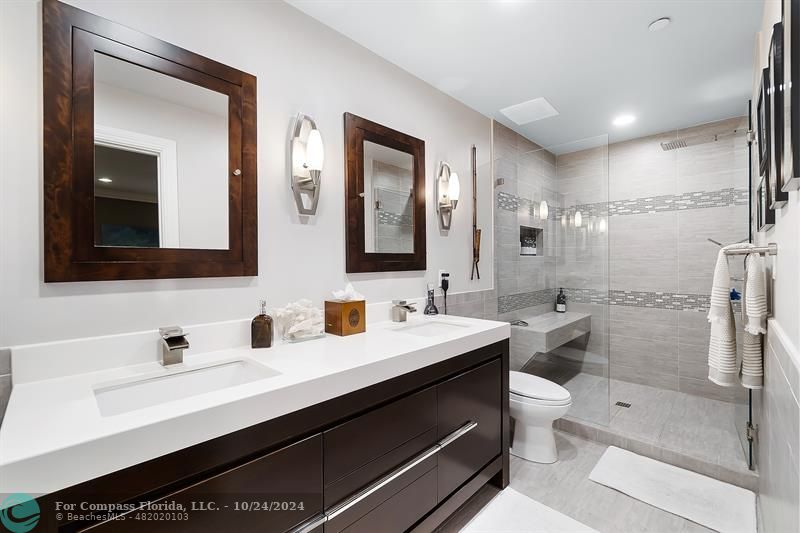301 Tarpon Drive Fort Lauderdale, FL 33301 - Photo 12 of 21 a bathroom with a double vanity sink toilet mirror and shower
