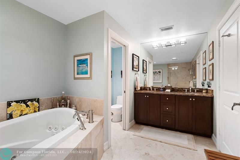 301 Tarpon Drive Fort Lauderdale, FL 33301 - Photo 15 of 21 a bathroom with a bathtub double vanity and sink