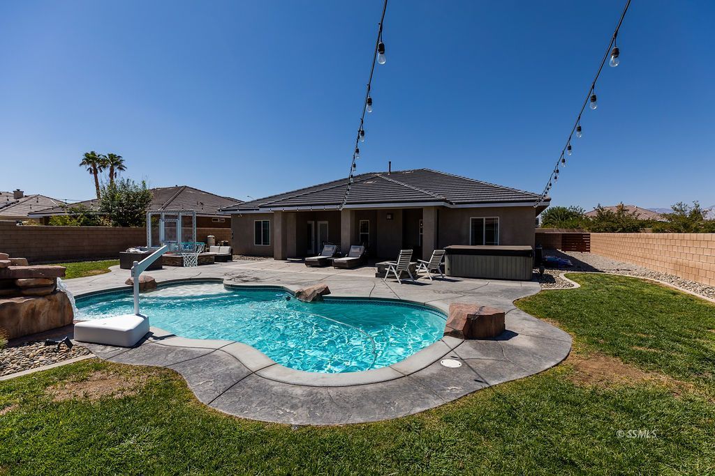 1030 Arroyo Street Ridgecrest, CA 93555 - Photo 35 of 49 a view of a house with backyard sitting area and swimming pool