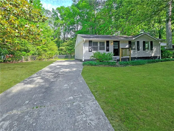 a view of house with backyard and garden