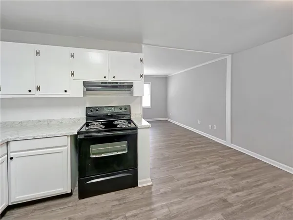 a stove top oven sitting inside of a kitchen
