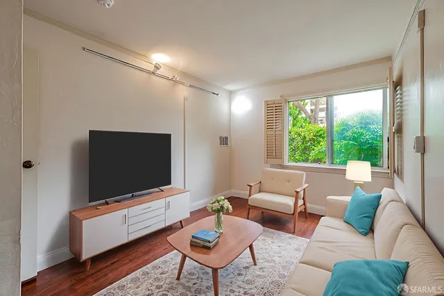 a living room with furniture and a flat screen tv