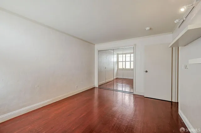 a view of wooden floor and windows in an empty room