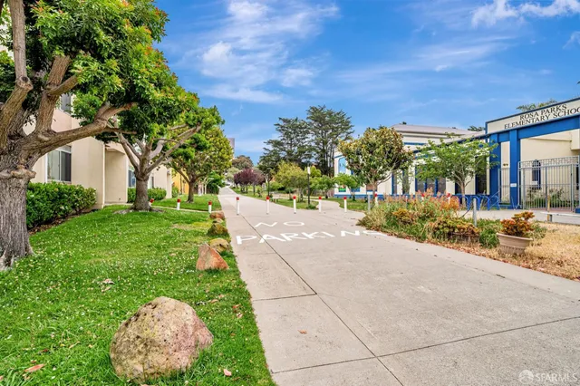 a view of a garden with a building in the background