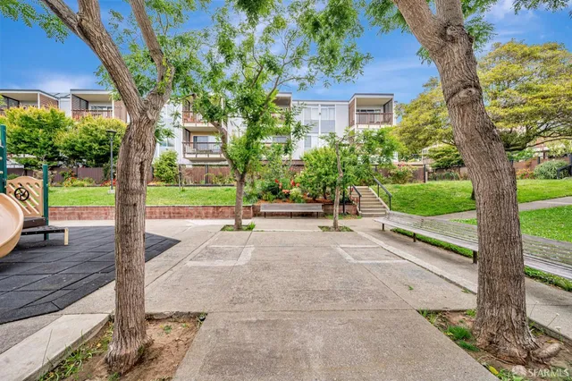 a view of a street with a house in the background