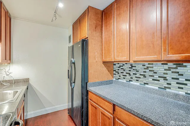a kitchen with a refrigerator and a sink