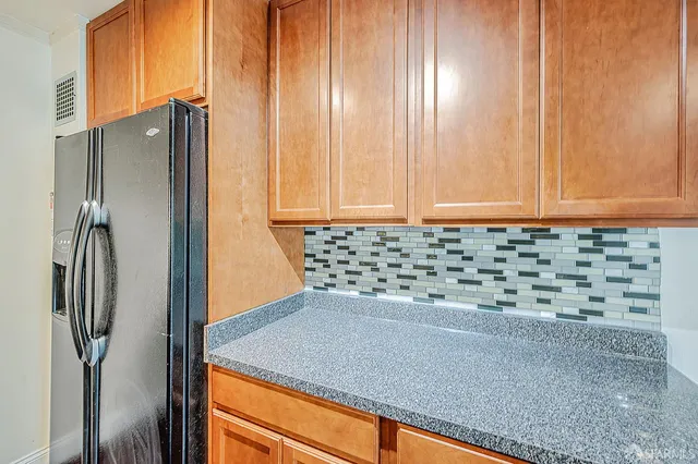 a kitchen with a refrigerator and cabinets