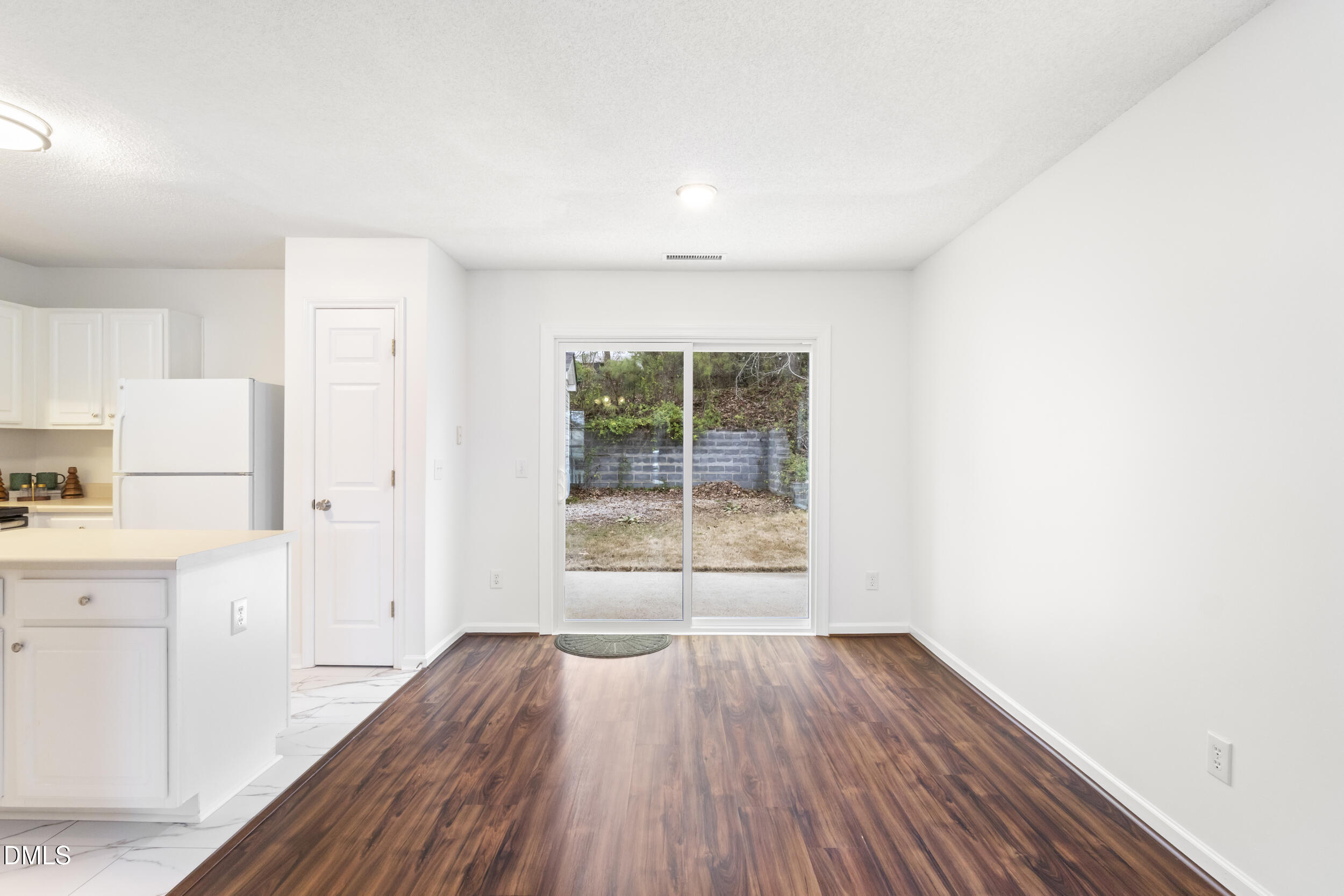 4616 Silverdene Street Raleigh, NC 27616 - Photo 11 of 42 a view of a kitchen with wooden floor and a window
