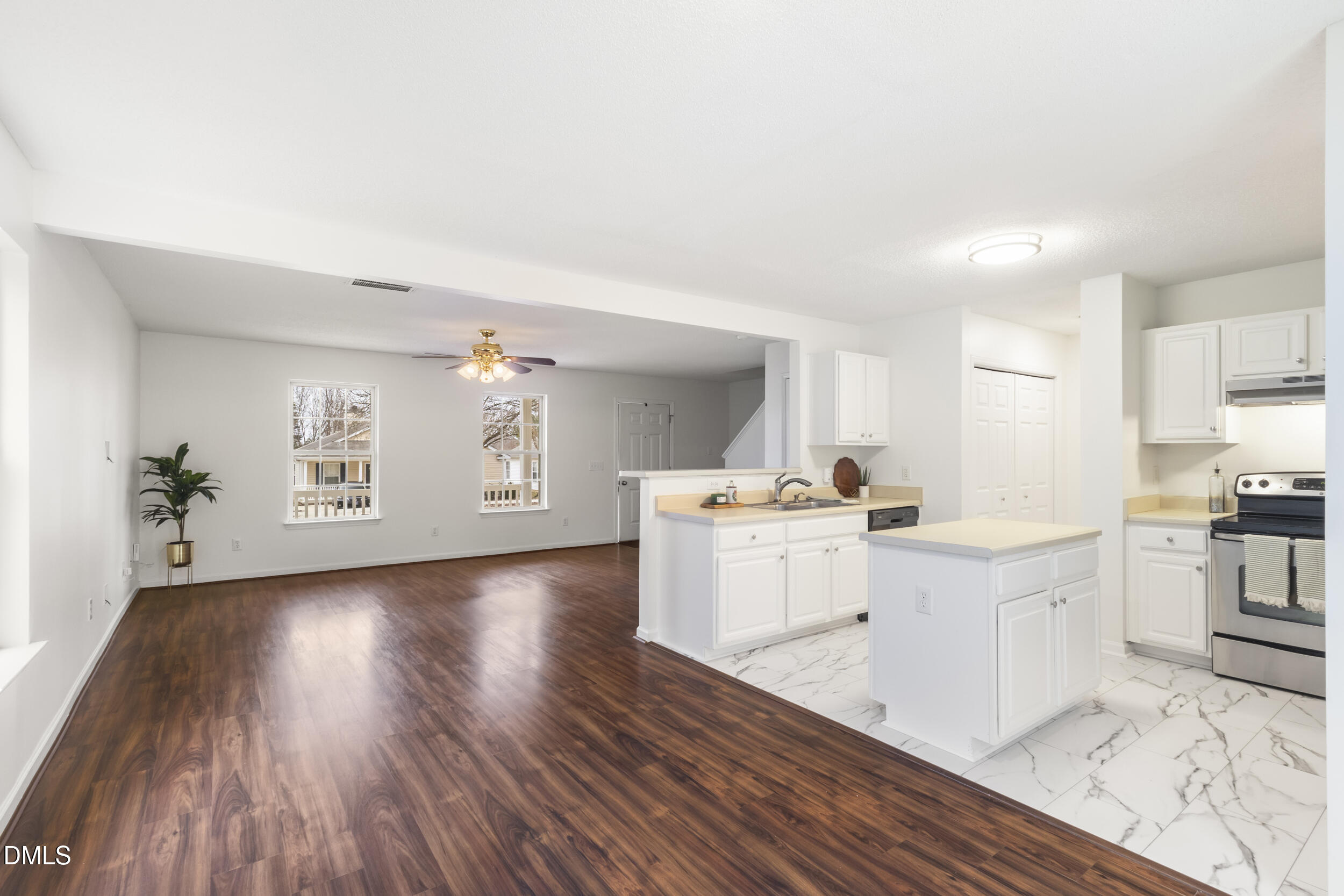4616 Silverdene Street Raleigh, NC 27616 - Photo 13 of 42 a kitchen with wooden floors and white appliances