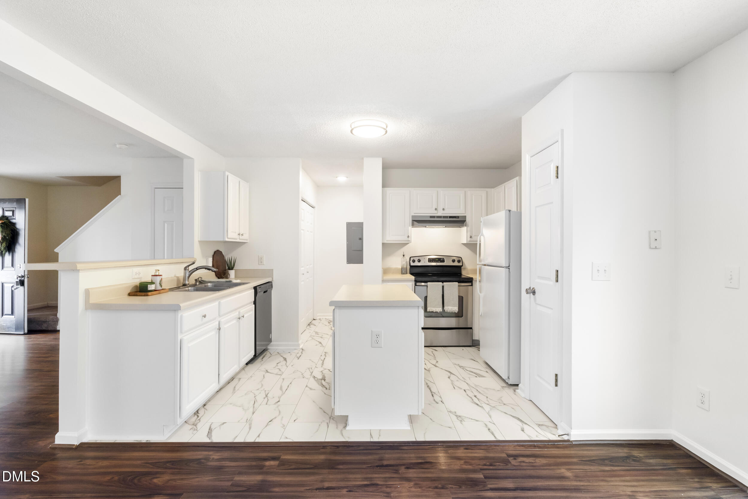 4616 Silverdene Street Raleigh, NC 27616 - Photo 14 of 42 a kitchen with stainless steel appliances wooden floors and refrigerator