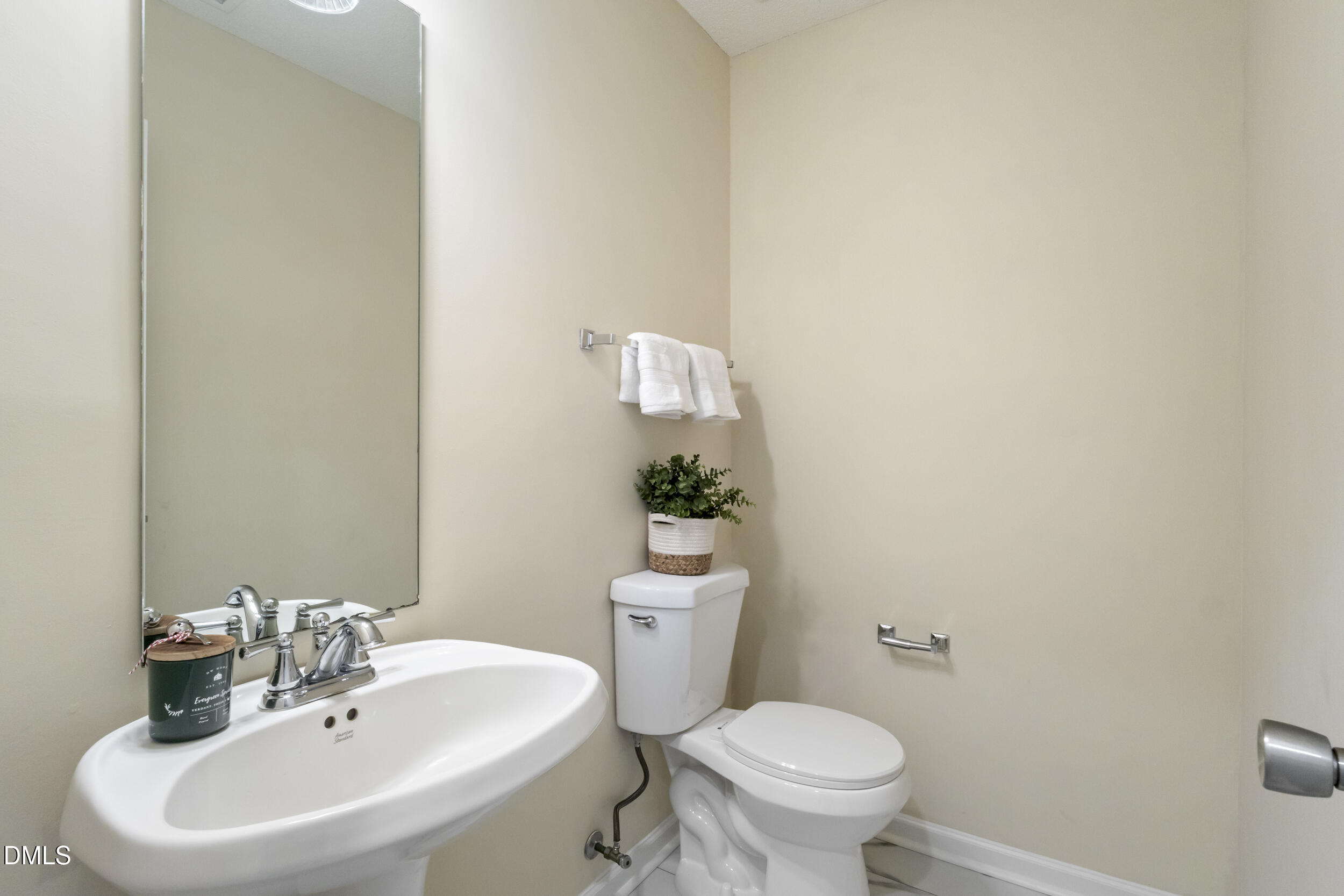 4616 Silverdene Street Raleigh, NC 27616 - Photo 19 of 42 a bathroom with a sink a toilet and mirror