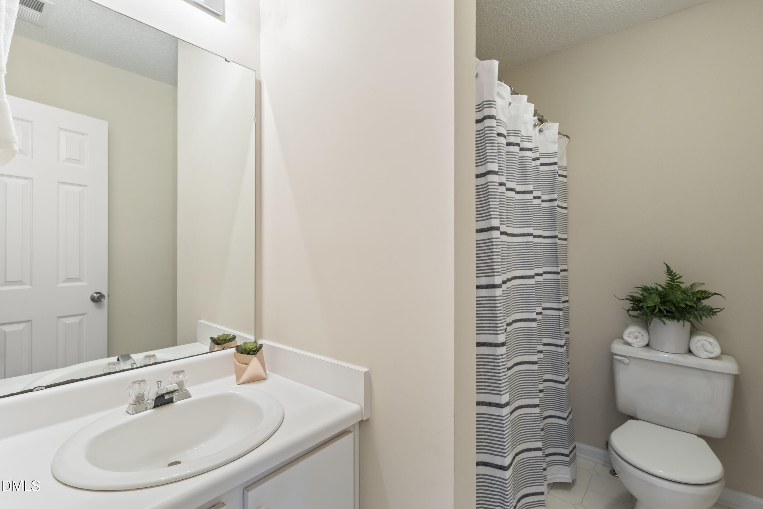 4616 Silverdene Street Raleigh, NC 27616 - Photo 22 of 42 a bathroom with a sink a toilet and shower