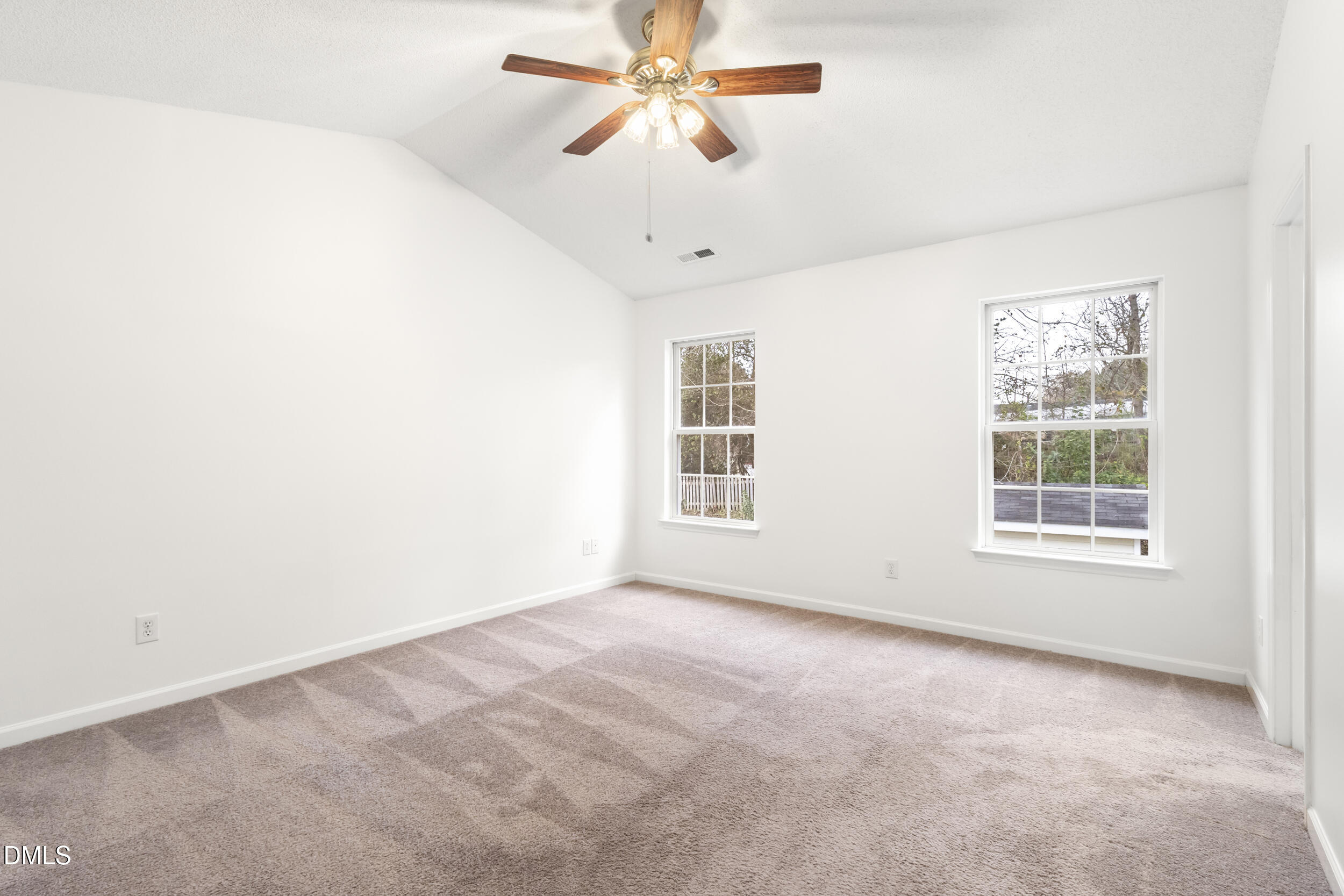 4616 Silverdene Street Raleigh, NC 27616 - Photo 25 of 42 an empty room with windows and fan