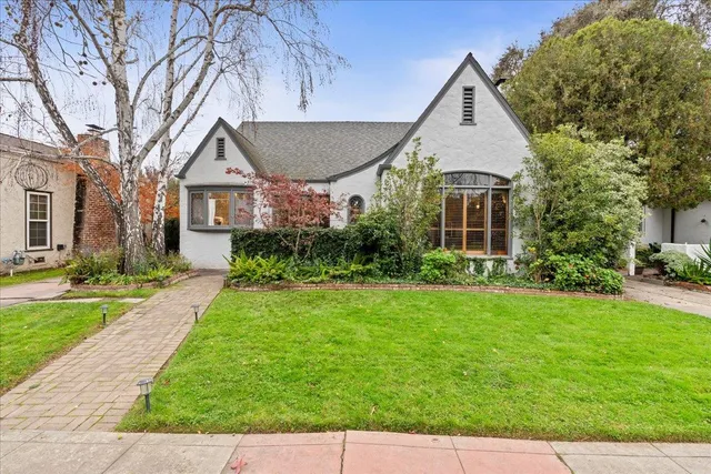 a front view of house with yard and green space