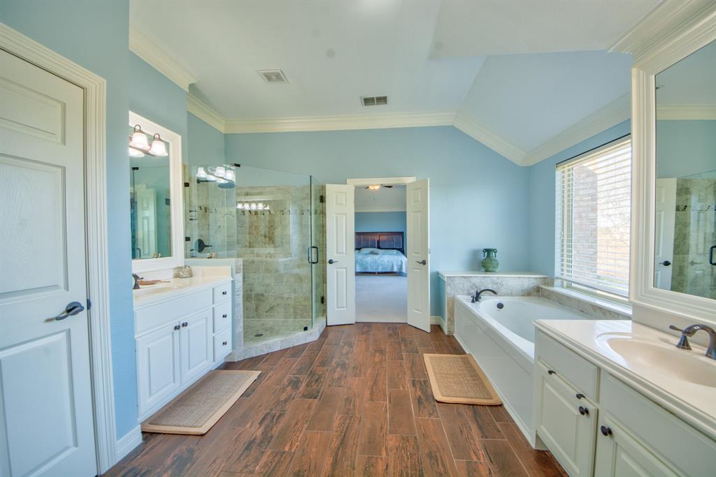 730 East Peninsula Drive Coppell, TX 75019 - Photo 15 of 34 a bathroom with a granite countertop double vanity sink a mirror and a bathtub