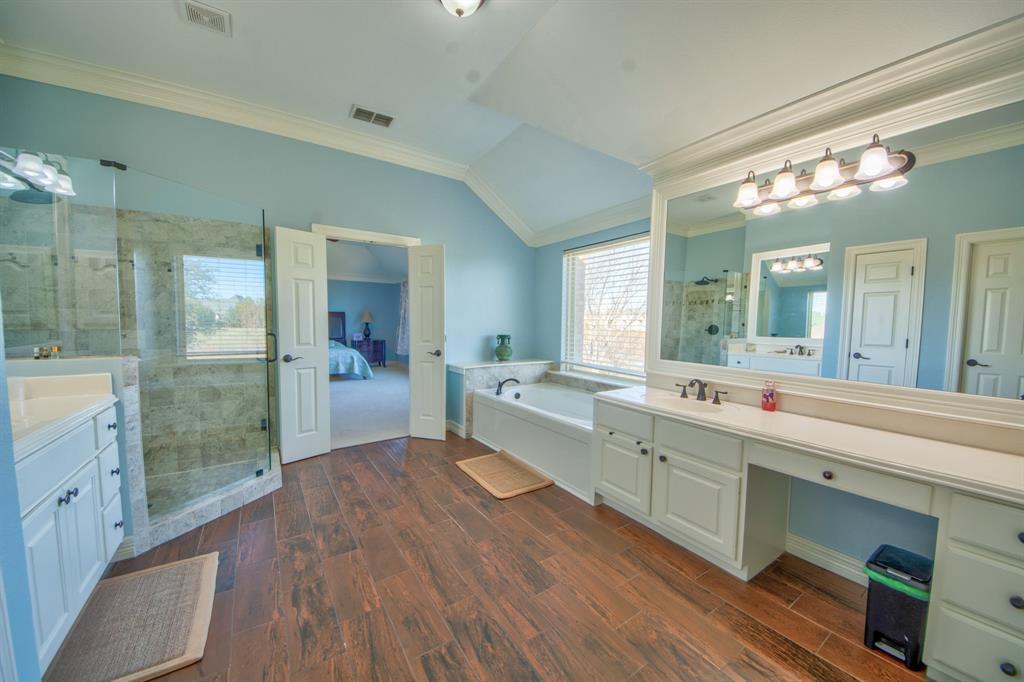 730 East Peninsula Drive Coppell, TX 75019 - Photo 16 of 34 a large bathroom with a large mirror vanity and double