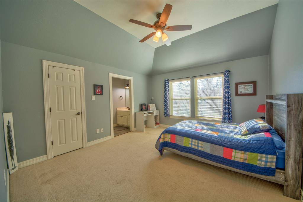 730 East Peninsula Drive Coppell, TX 75019 - Photo 21 of 34 a bedroom with a bed and a chandelier