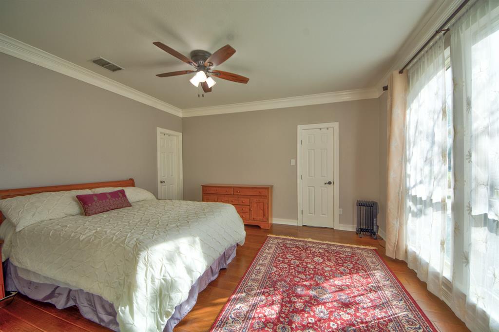 730 East Peninsula Drive Coppell, TX 75019 - Photo 23 of 34 a bedroom with a large bed and a chandelier