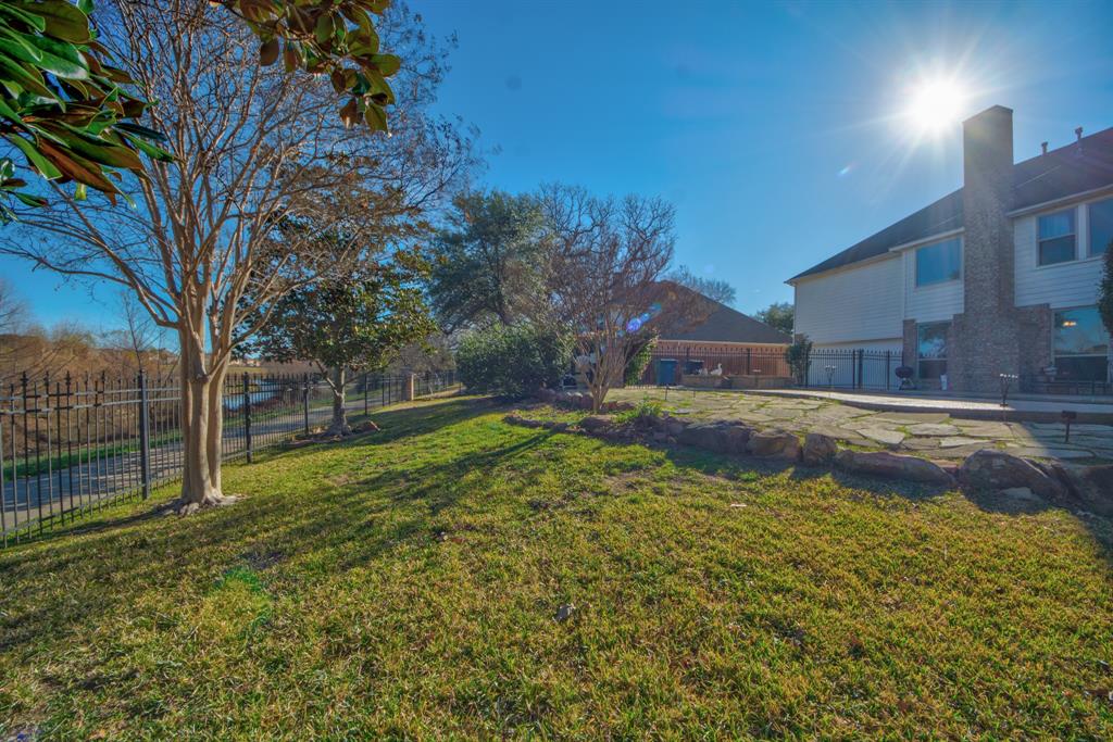 730 East Peninsula Drive Coppell, TX 75019 - Photo 29 of 34 a view of yard with swimming pool and trees