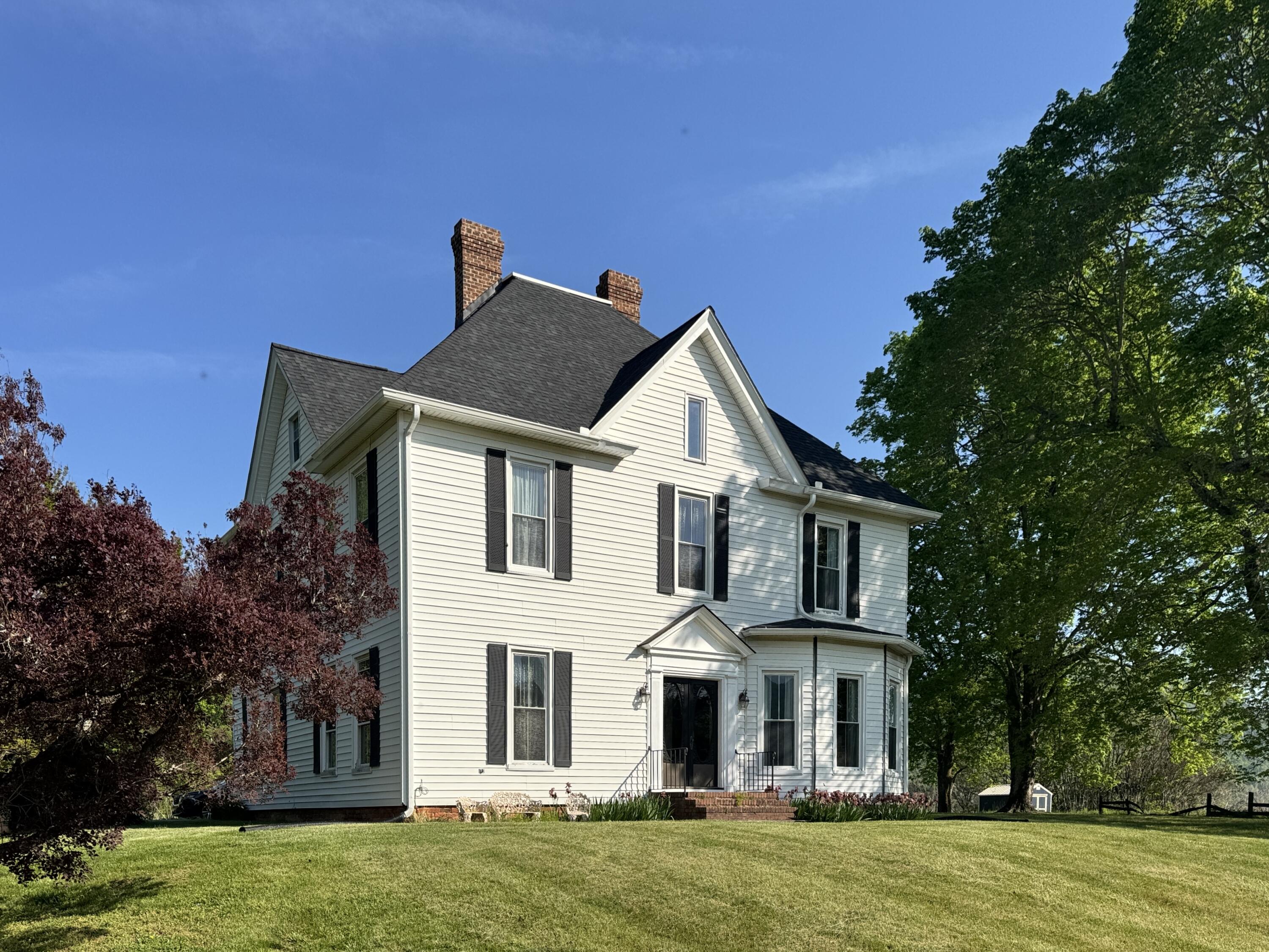 17749 Main Street Buchanan, VA 24066 - Photo 1 of 58 a front view of a house with a garden