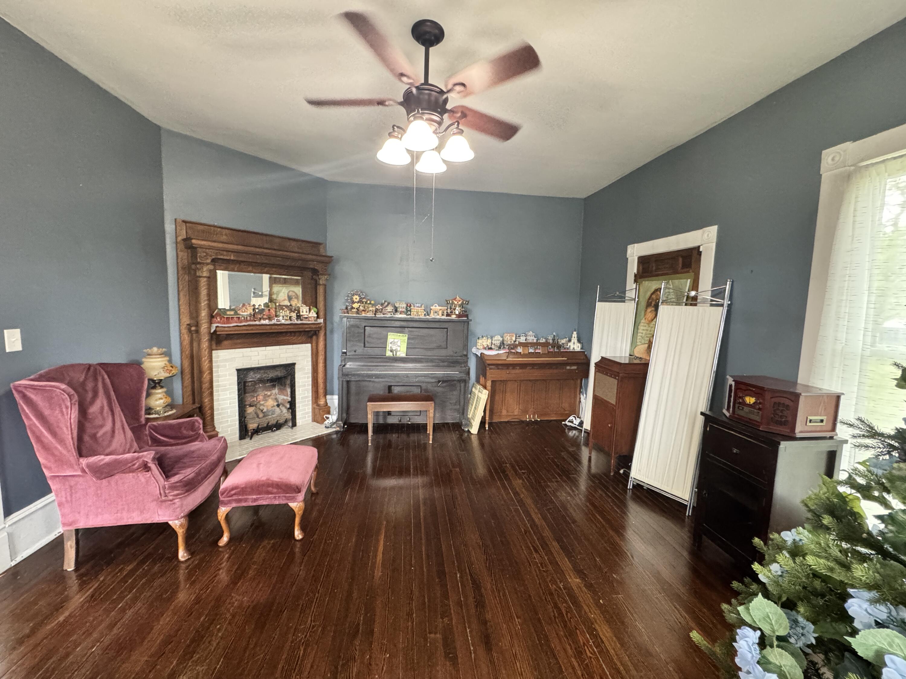 17749 Main Street Buchanan, VA 24066 - Photo 21 of 58 a living room with furniture a fireplace and a window