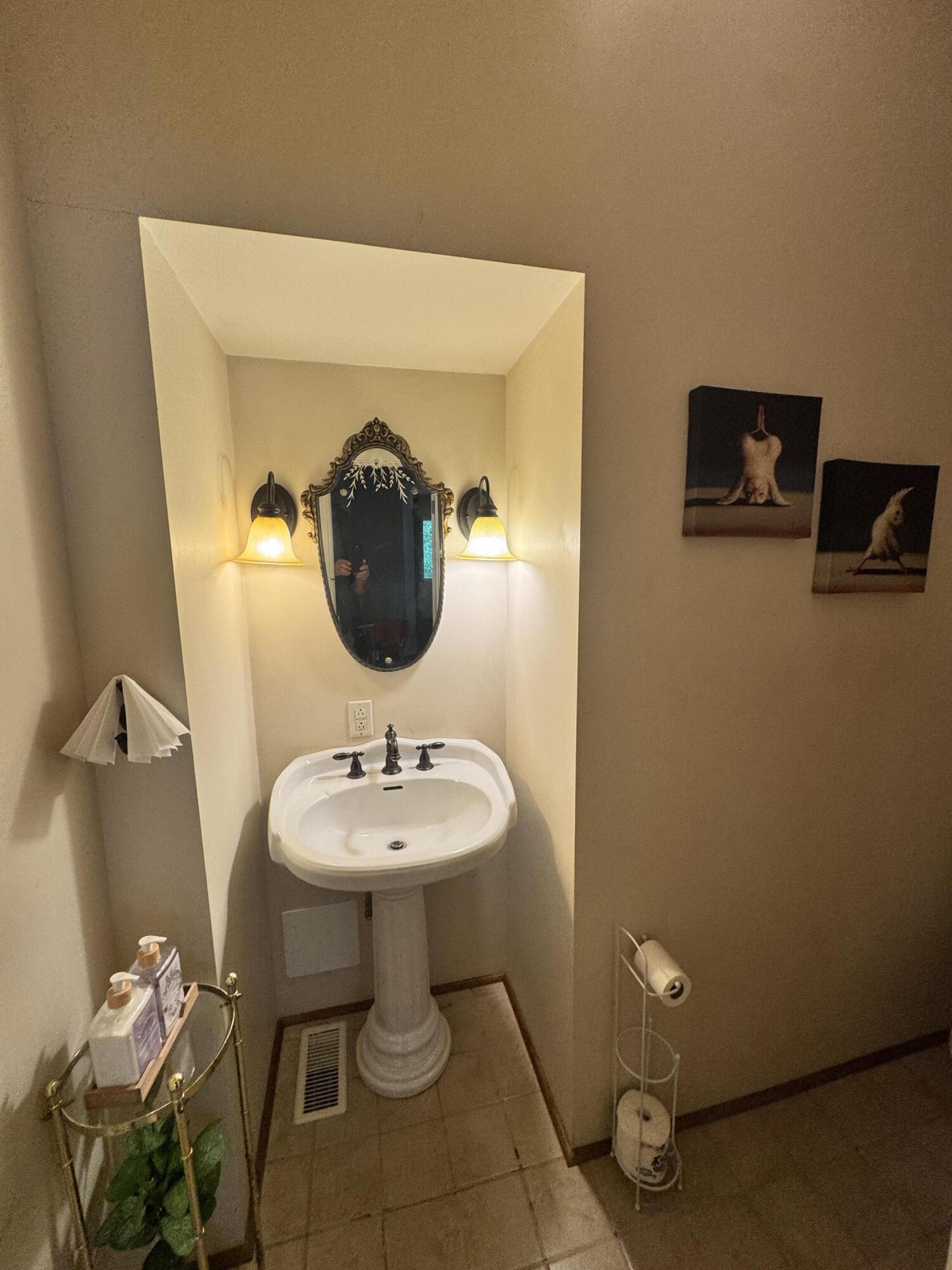 17749 Main Street Buchanan, VA 24066 - Photo 33 of 58 a bathroom with a toilet sink and mirror
