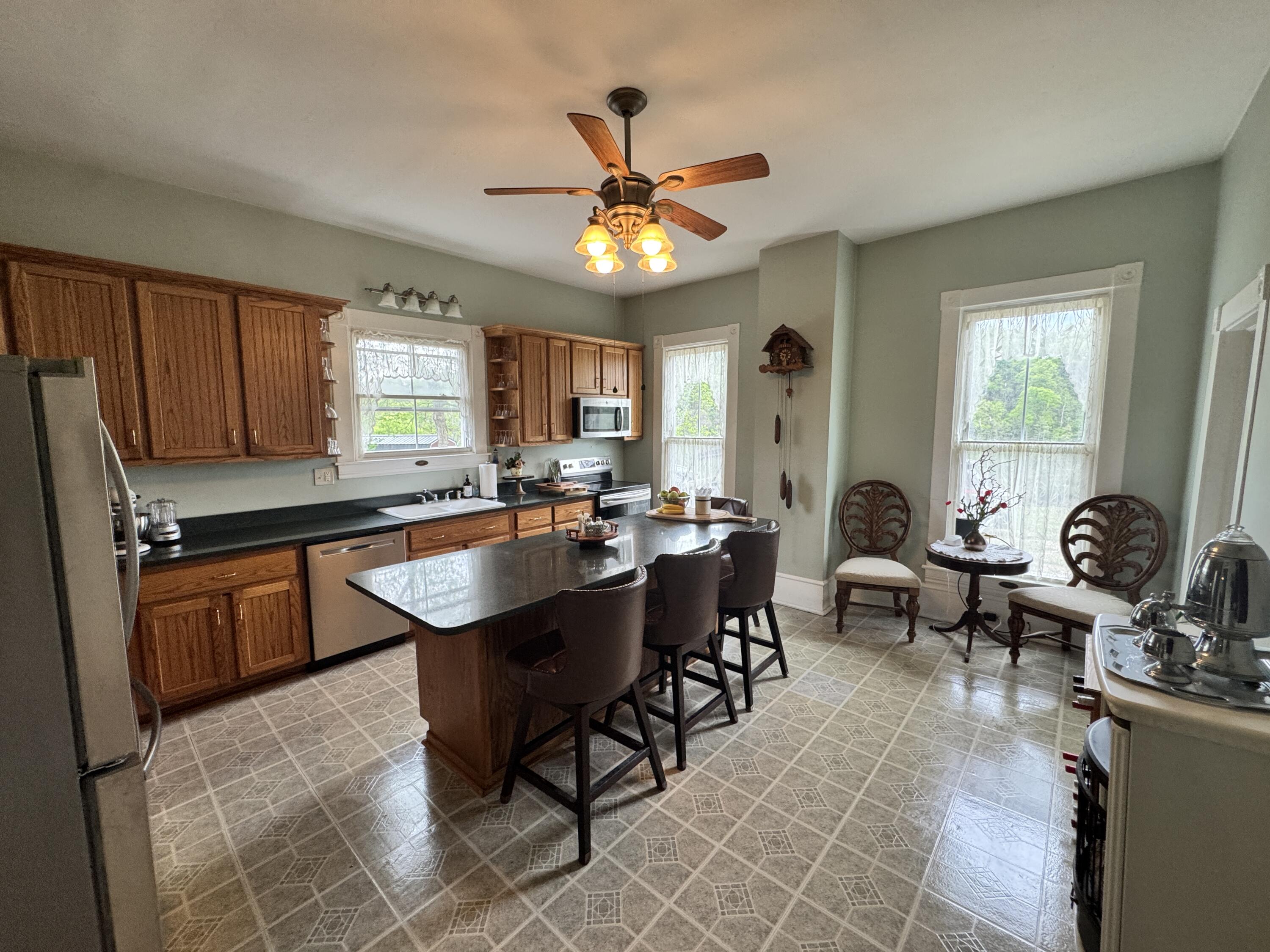 17749 Main Street Buchanan, VA 24066 - Photo 49 of 58 a kitchen with granite countertop sink cabinets and window