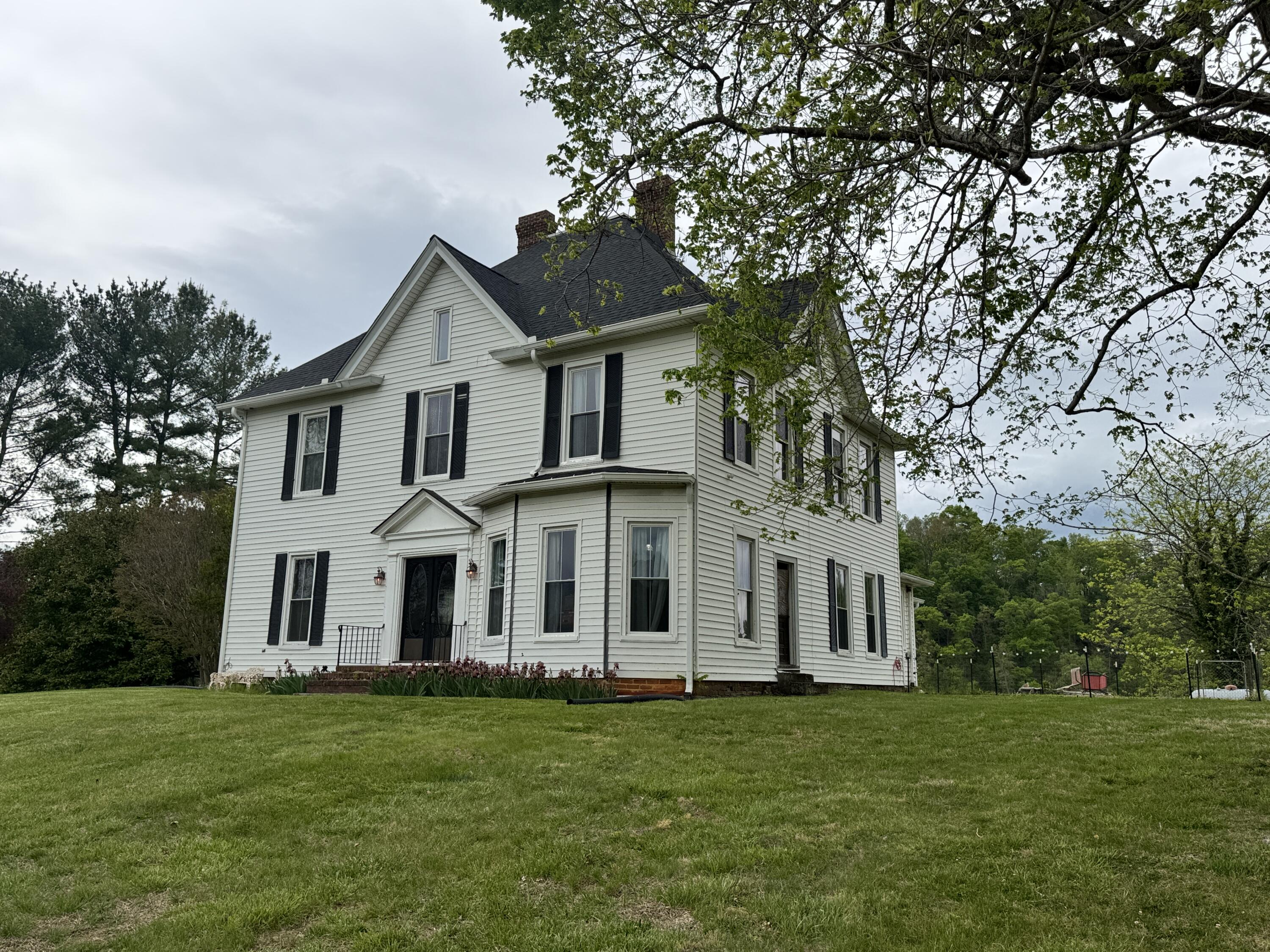 17749 Main Street Buchanan, VA 24066 - Photo 58 of 58 a front view of a house with a garden