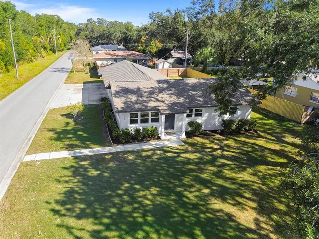 a aerial view of residential houses with yard and swimming pool