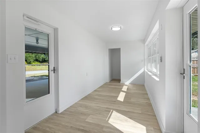 a view of entryway and hall with wooden floor