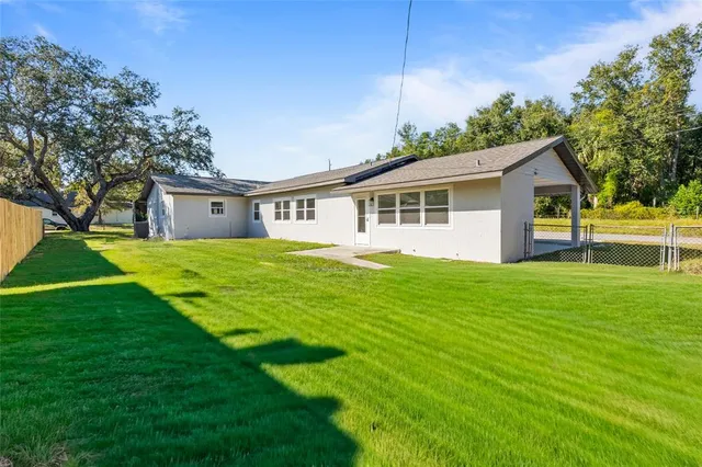 a house view with swimming pool in front of it