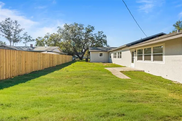 a view of a house with a backyard