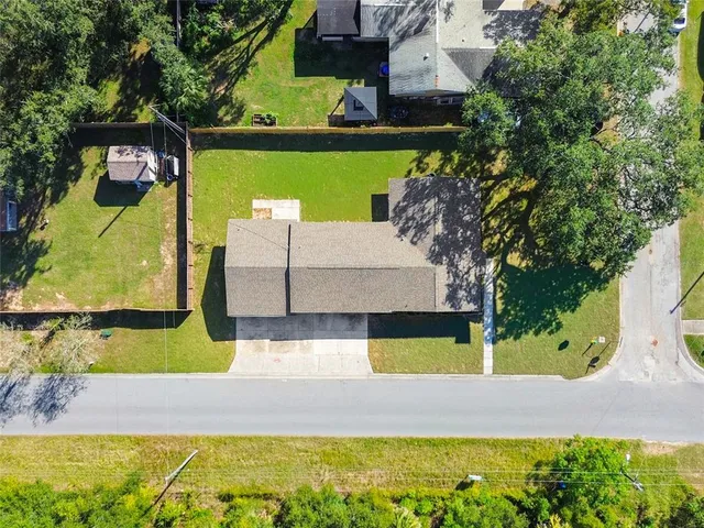 an aerial view of a house with a yard