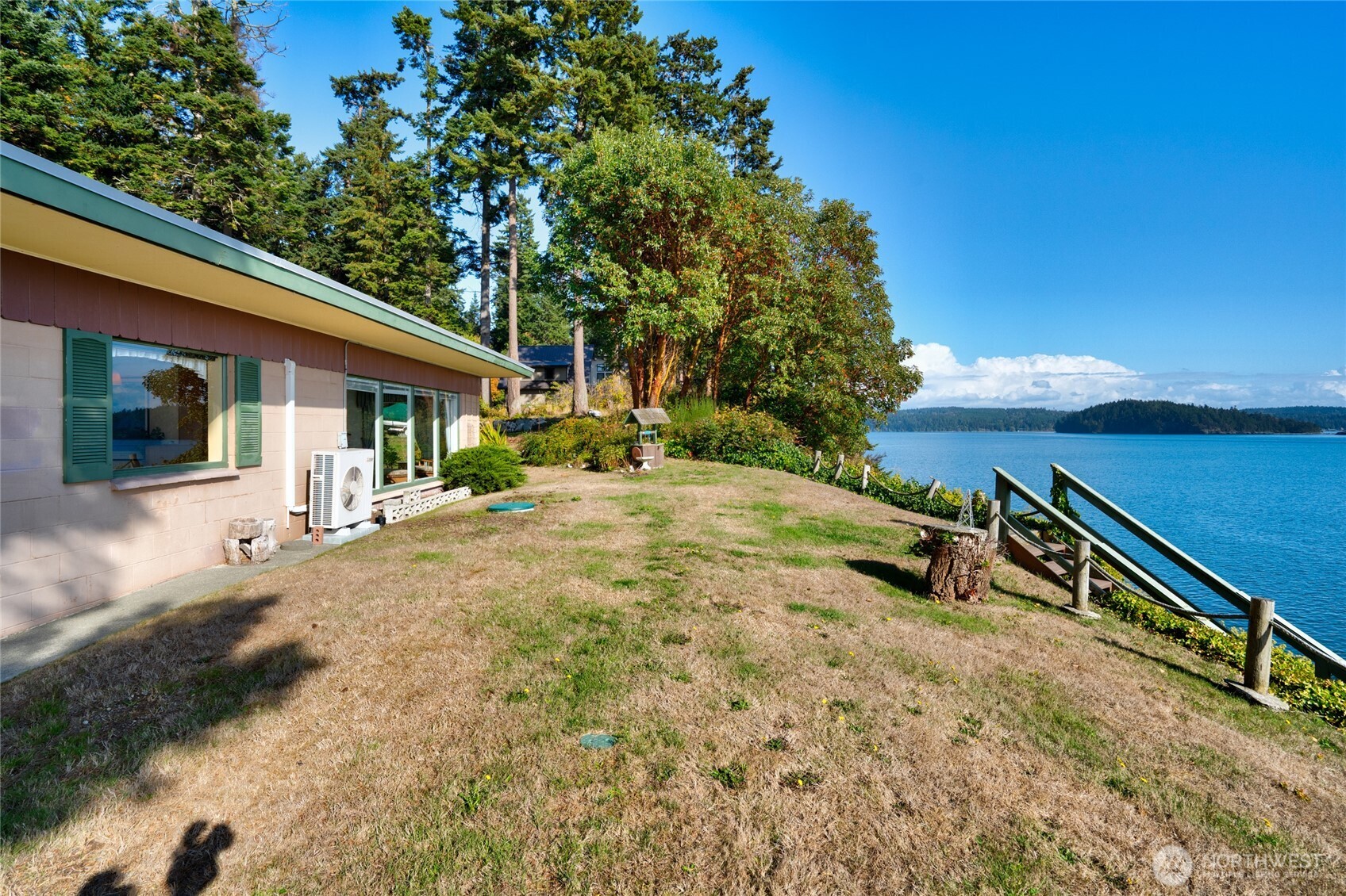 6860 Salmon Beach Road Anacortes, WA 98221 - Photo 12 of 39 a backyard of a house with table and chairs