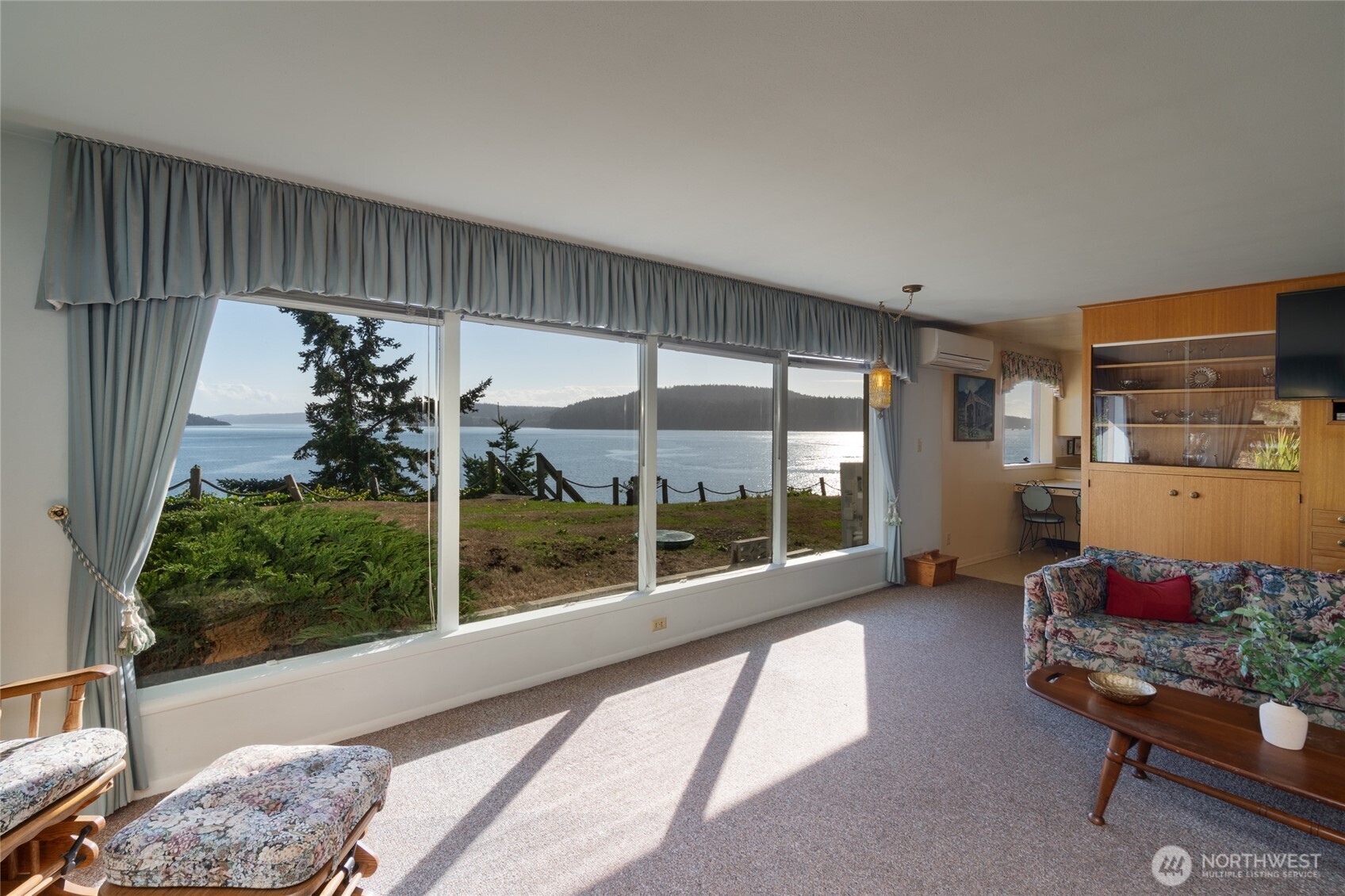 6860 Salmon Beach Road Anacortes, WA 98221 - Photo 24 of 39 a living room with furniture and a floor to ceiling window