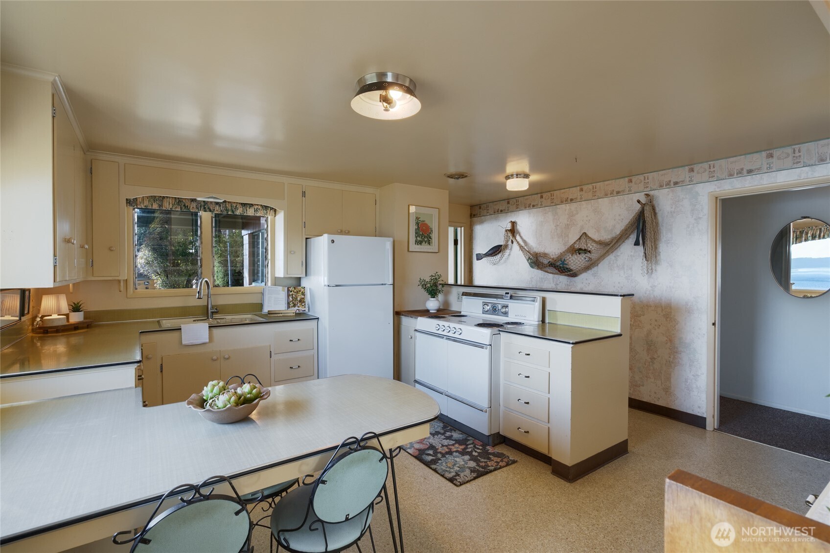 6860 Salmon Beach Road Anacortes, WA 98221 - Photo 27 of 39 a kitchen with a sink cabinets and wooden floor