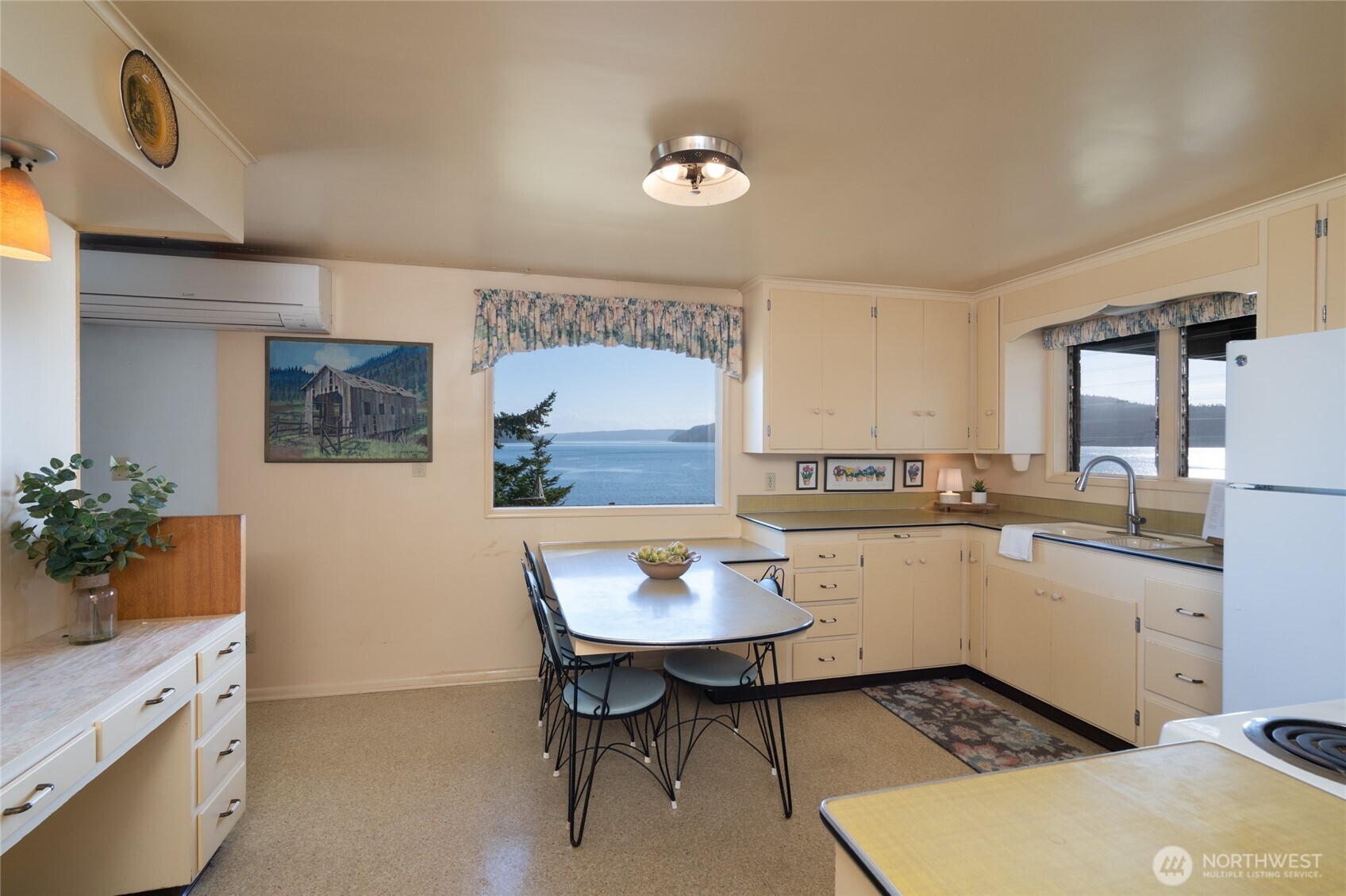 6860 Salmon Beach Road Anacortes, WA 98221 - Photo 28 of 39 a kitchen with a sink cabinets and wooden floor
